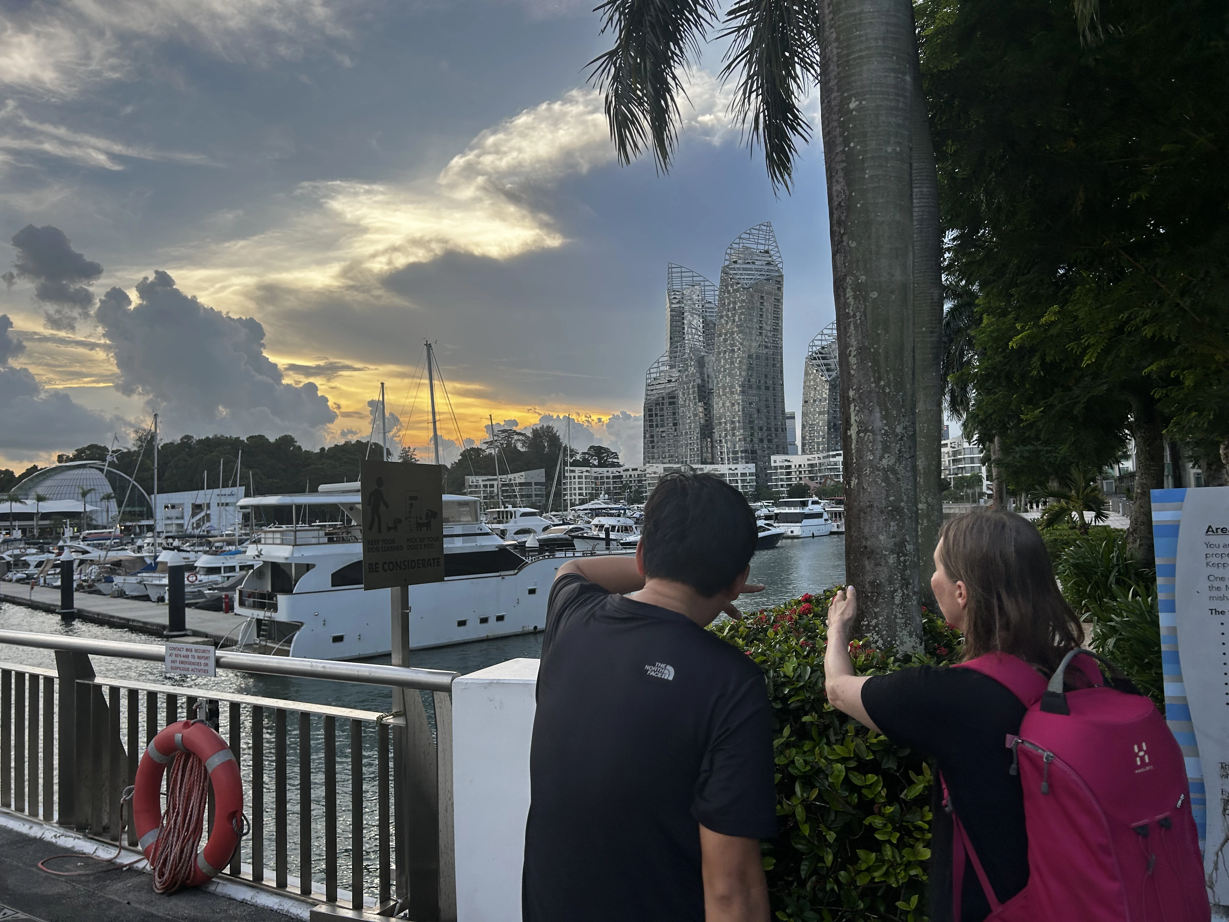 Tour guide pointing out the harbour views to a guest on Mount Faber