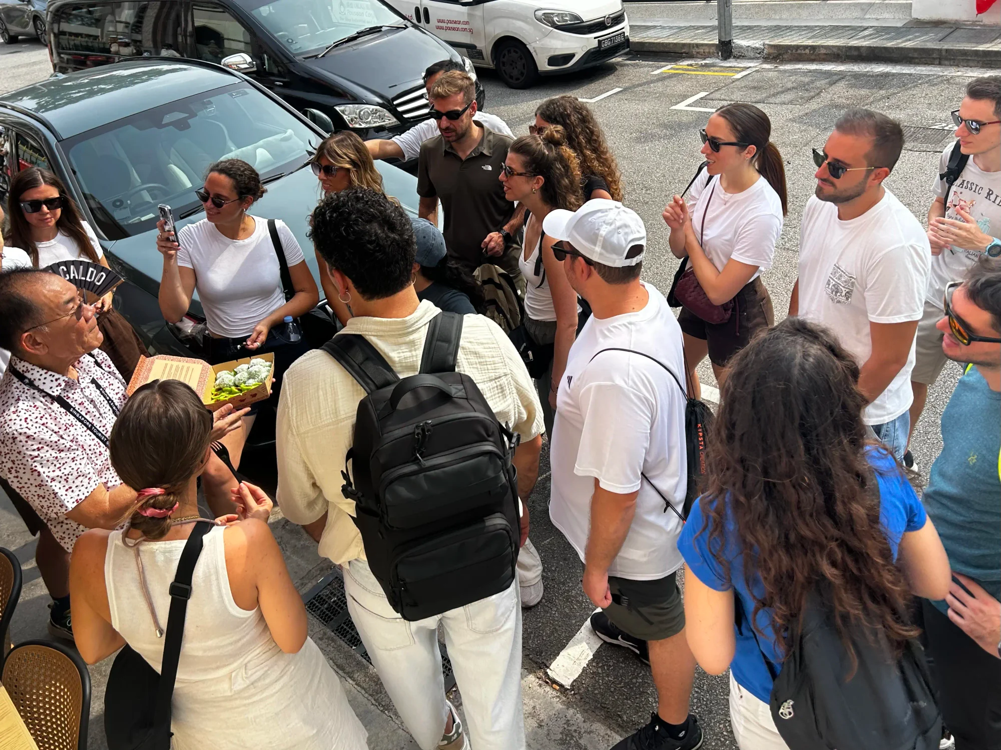 Walking tour guests learning about and tasting traditional Malay kueh