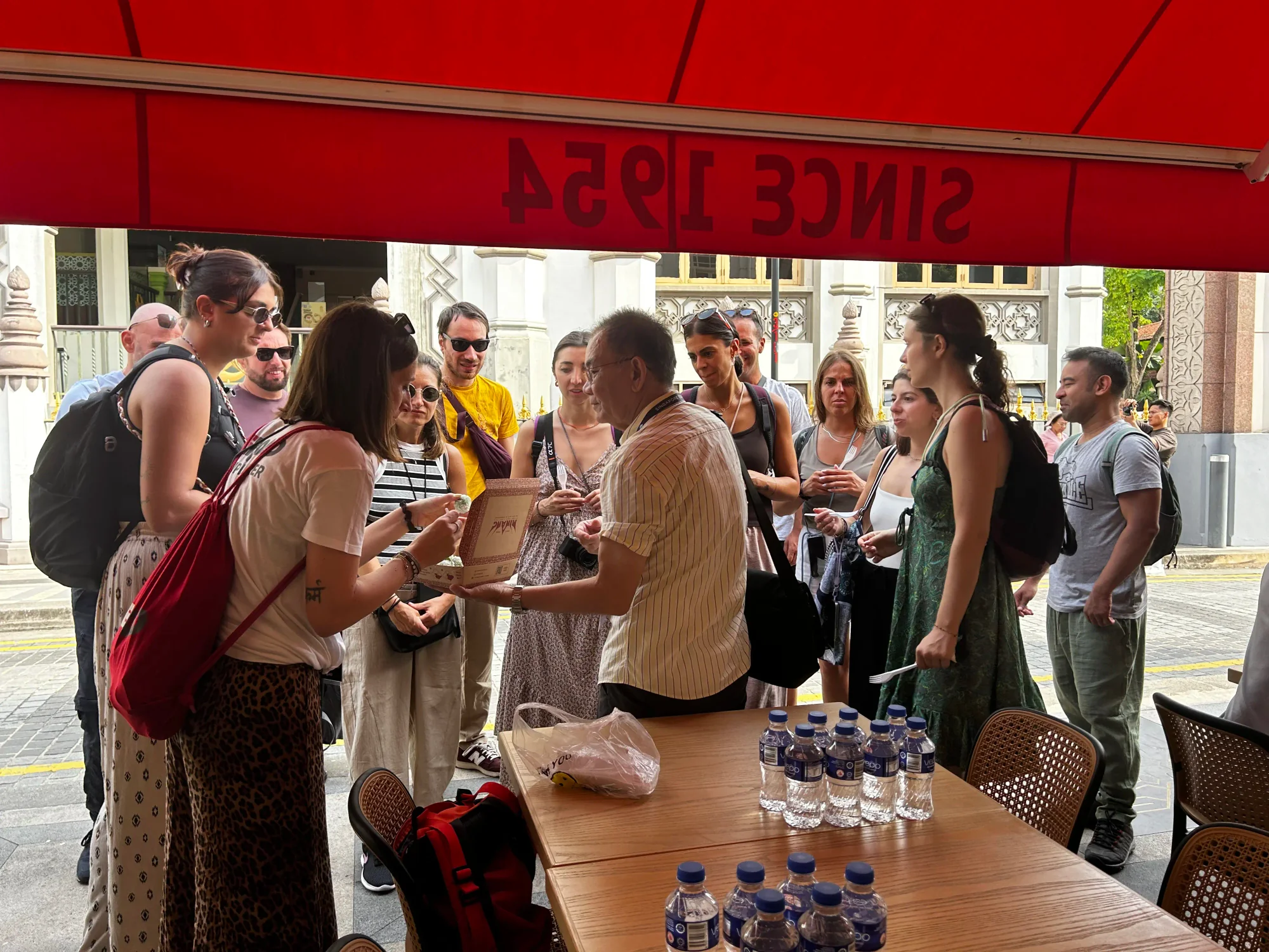 Tour group tasting Malay kueh together during their heritage walk