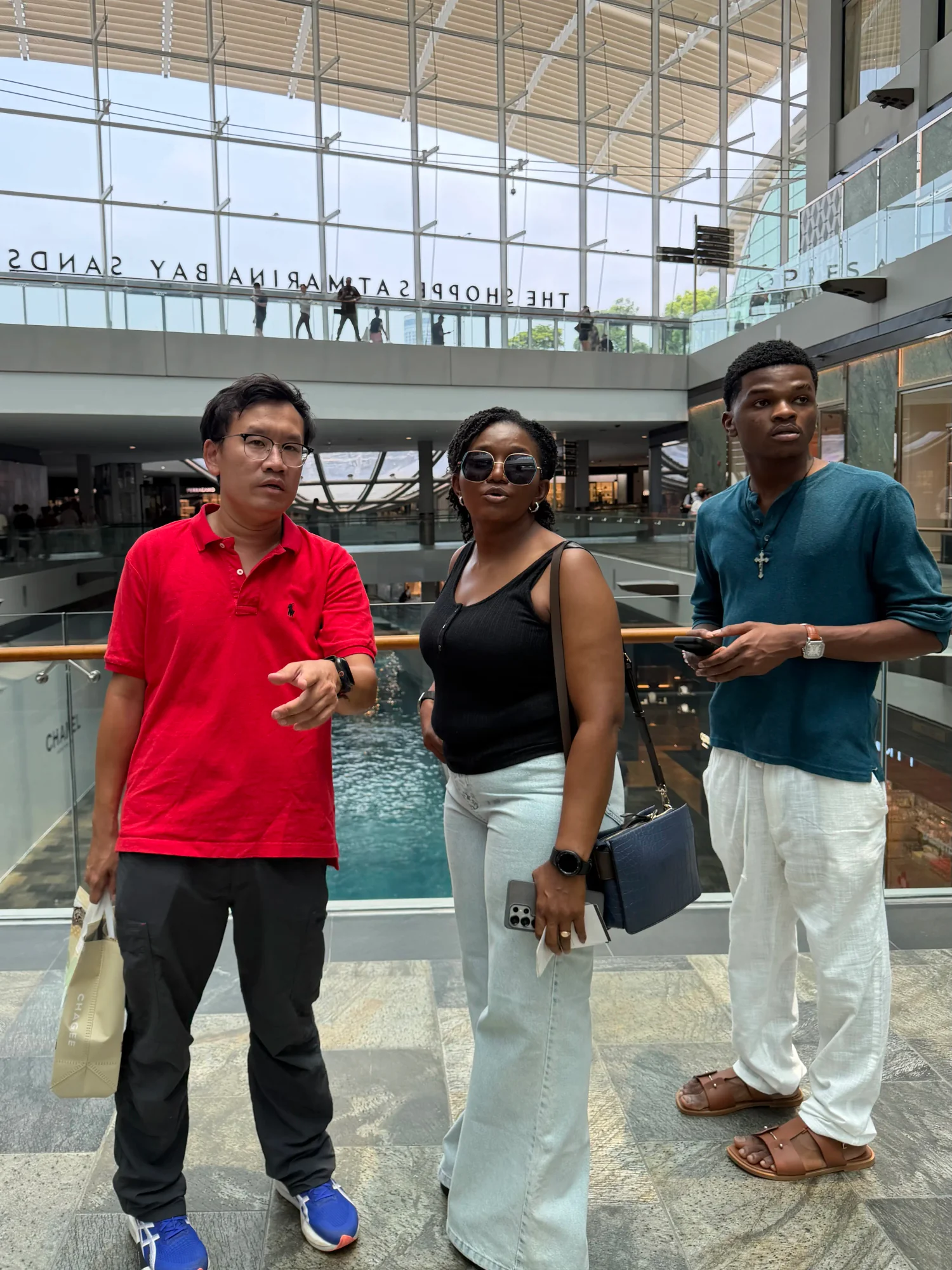 Tour guide explaining the design of The Shoppes at Marina Bay Sands to walking tour guests