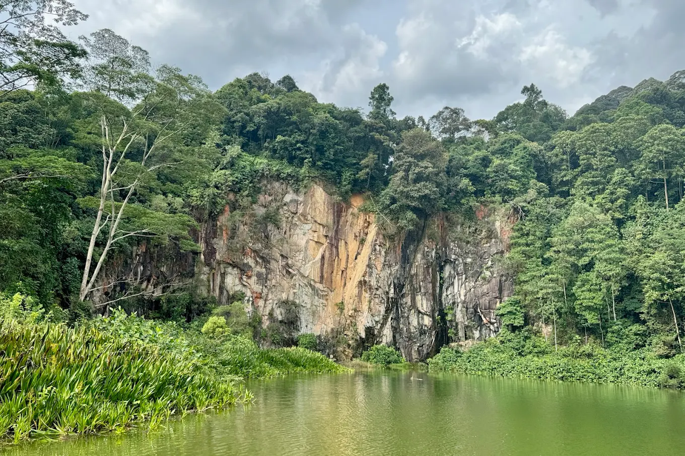 Granite cliffs and the calm lake at Singapore Quarry