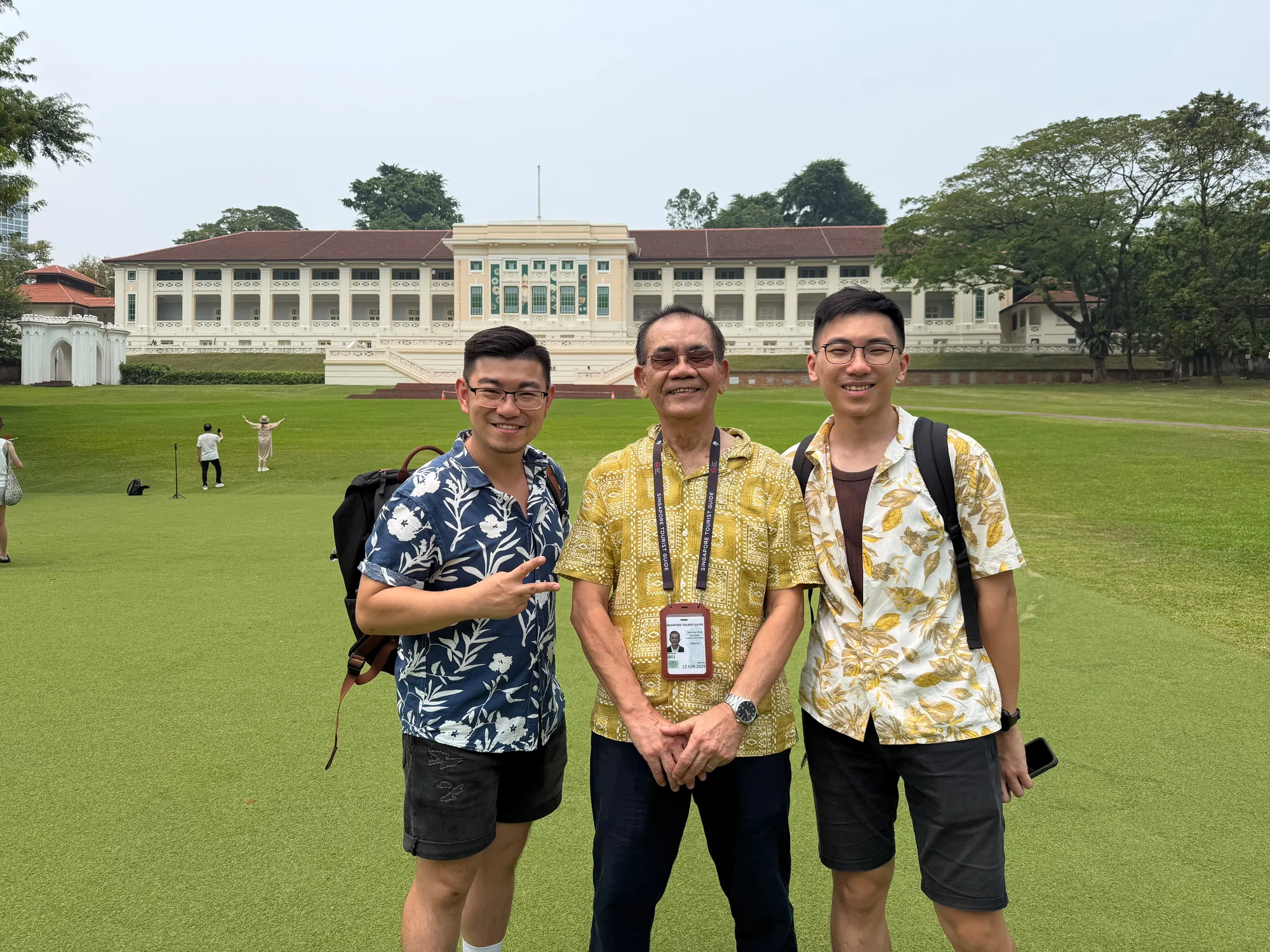 Tour guide and guests on Fort Canning Green in front of Fort Canning Centre